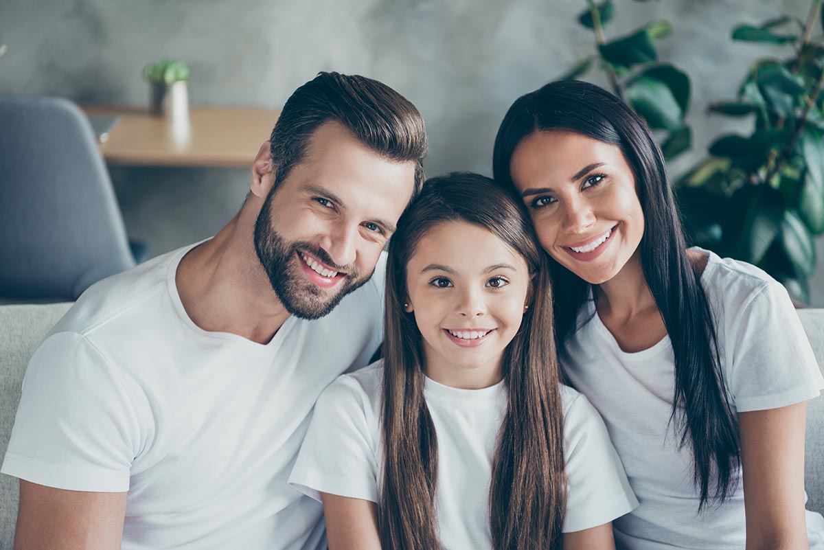 family-of-three-big-smiles