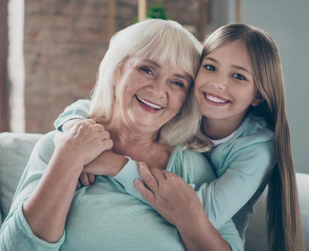 grandmother-grandaughter-hugging-smiling