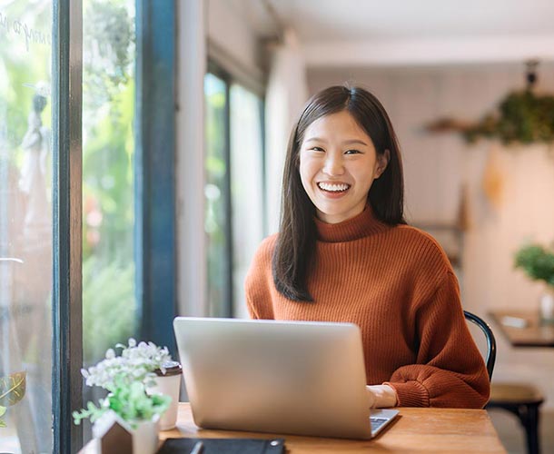 smiling-woman-on-laptop-at-home